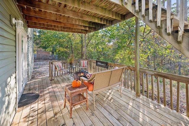 wooden deck with an outdoor fire pit