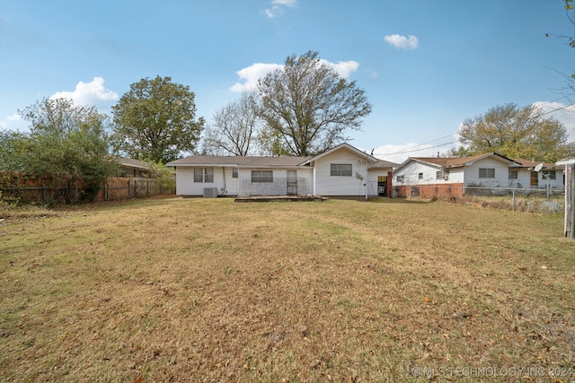 back of house featuring a yard