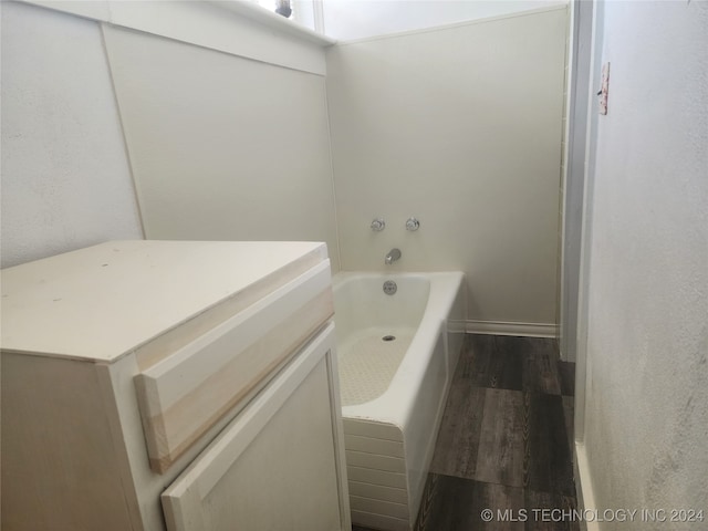 bathroom with hardwood / wood-style floors and a bathing tub