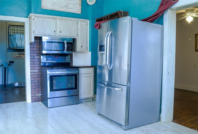 kitchen with backsplash, stainless steel appliances, light hardwood / wood-style floors, and ceiling fan