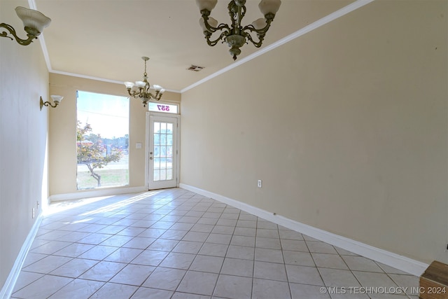 empty room featuring light tile patterned floors, crown molding, and a chandelier