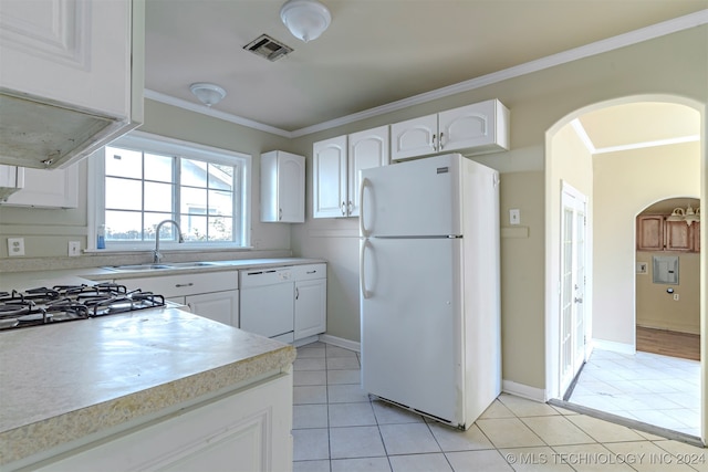 kitchen featuring white appliances, sink, light tile patterned floors, and white cabinetry