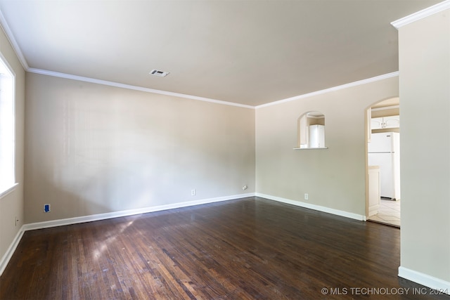 unfurnished room featuring ornamental molding, a healthy amount of sunlight, and dark hardwood / wood-style floors