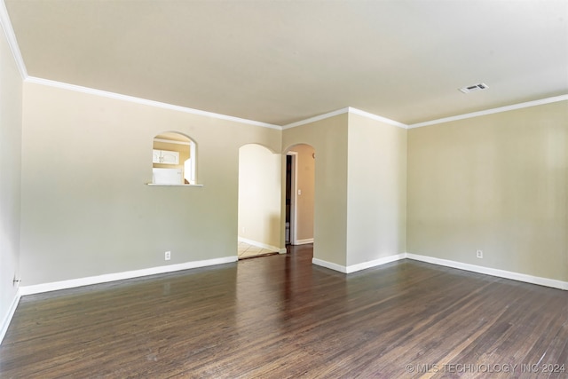 empty room with crown molding and dark hardwood / wood-style floors