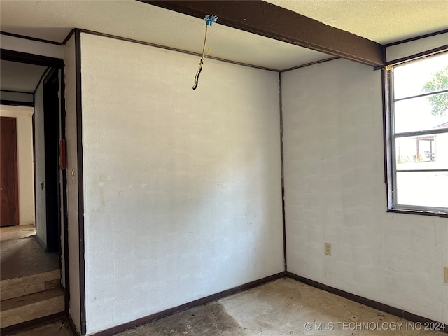 empty room featuring concrete floors and a textured ceiling