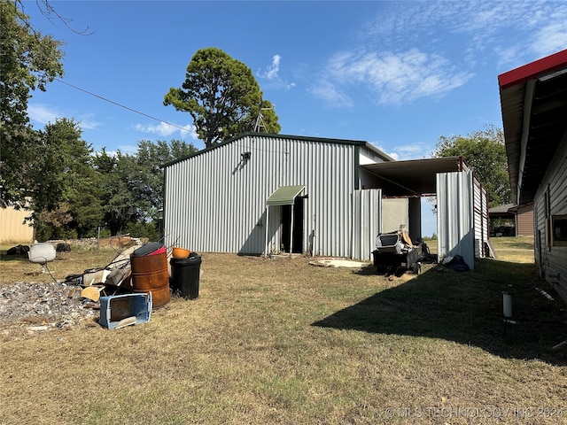 view of outbuilding with a yard