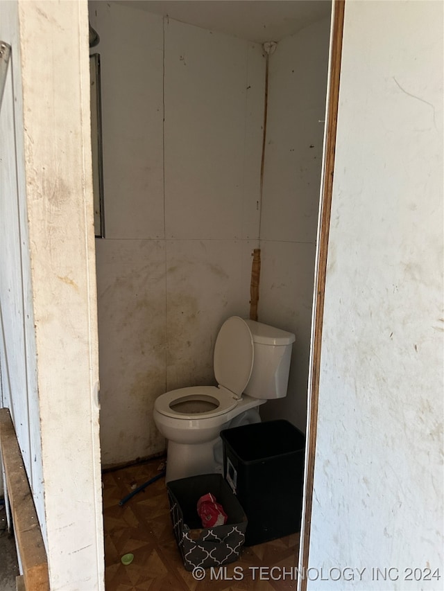 bathroom with parquet flooring and toilet