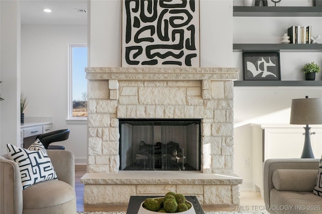 details with a stone fireplace and hardwood / wood-style floors