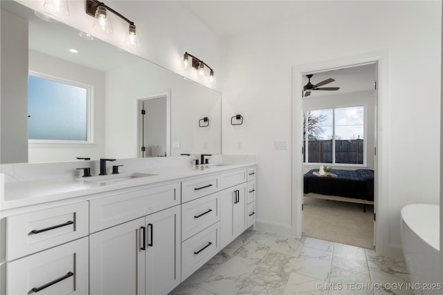 bathroom featuring ceiling fan, a bath, and vanity