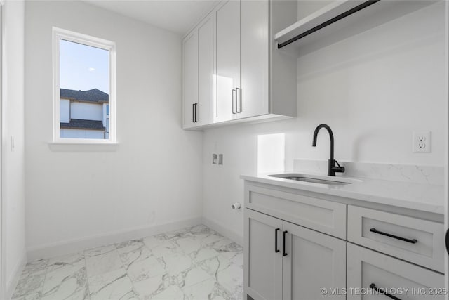 laundry area with cabinets, washer hookup, and sink