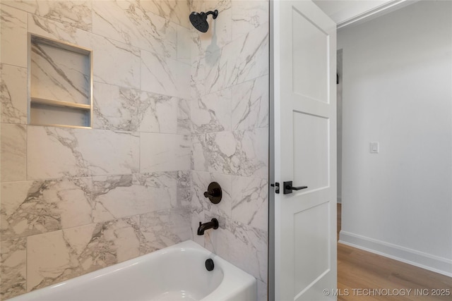 bathroom with wood-type flooring and tiled shower / bath combo