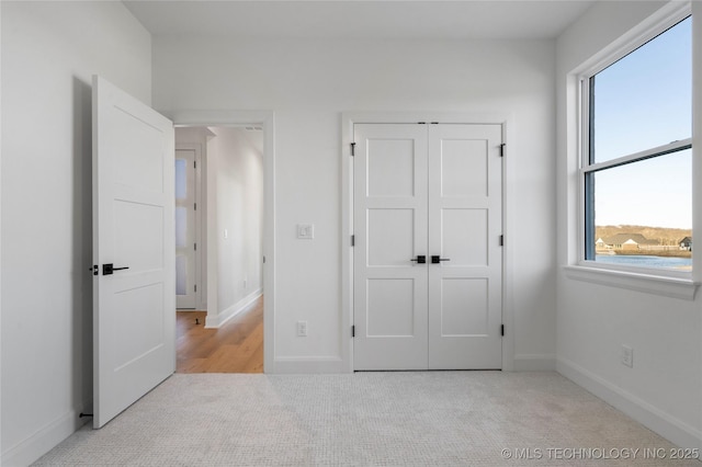 unfurnished bedroom with light colored carpet