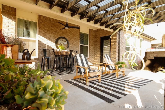 view of patio with ceiling fan and an outdoor bar