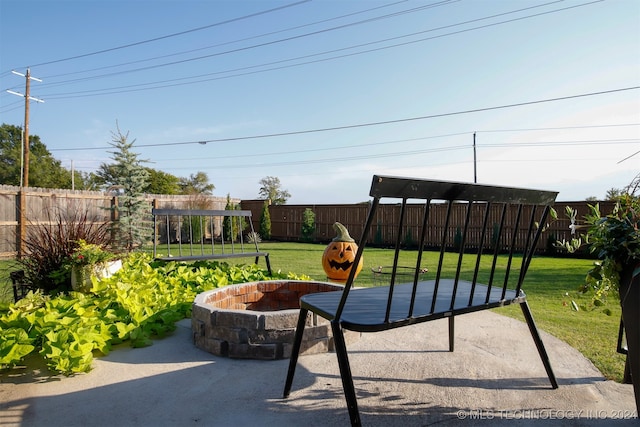 view of patio featuring a playground and an outdoor fire pit