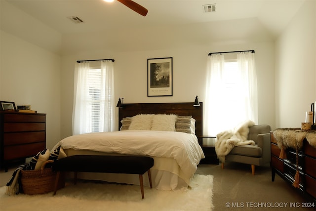 bedroom with ceiling fan, carpet, and vaulted ceiling