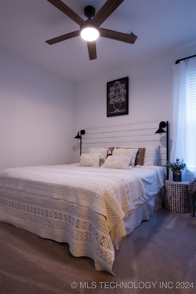 bedroom with ceiling fan and carpet floors