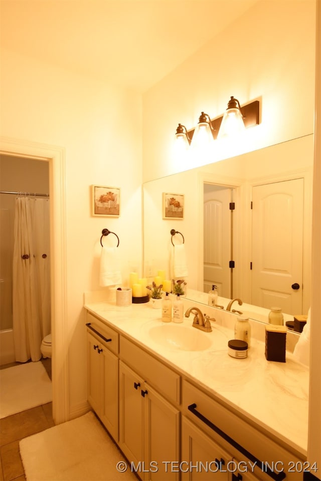 bathroom featuring toilet, tile patterned flooring, vanity, and walk in shower