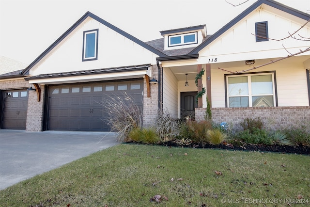 view of front of property with a garage and a front lawn