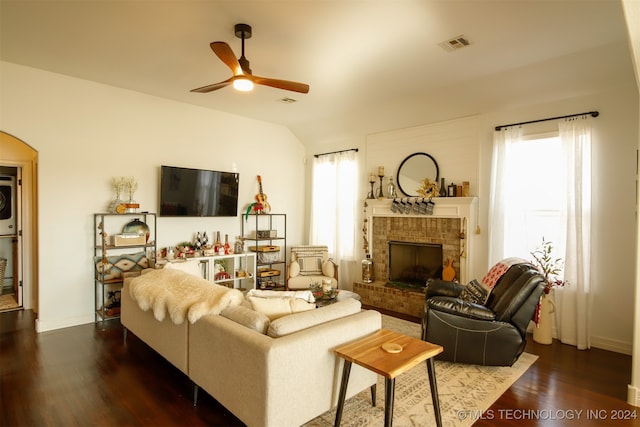 living room featuring a fireplace, dark hardwood / wood-style flooring, vaulted ceiling, and ceiling fan