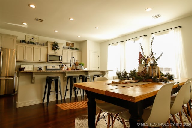 dining room with dark hardwood / wood-style flooring