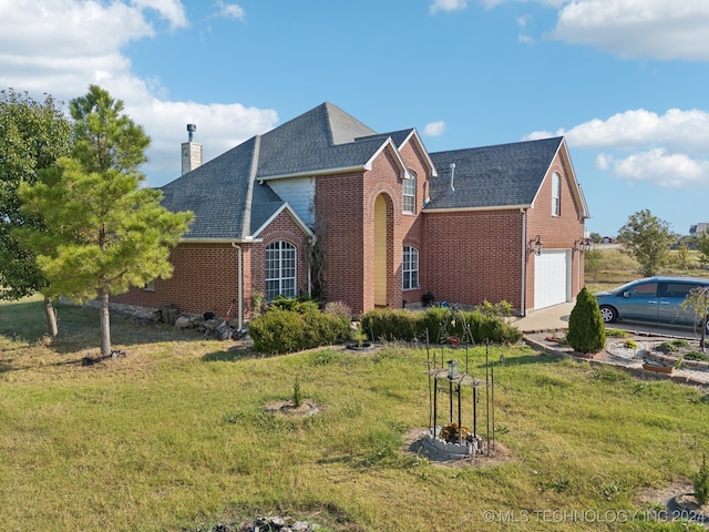 exterior space featuring a garage and a yard