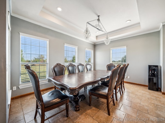 dining room featuring a notable chandelier, crown molding, and a raised ceiling