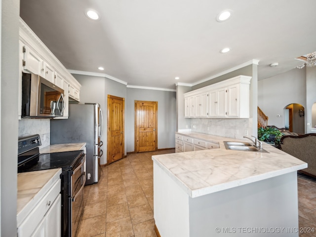 kitchen with black electric range oven, white cabinetry, sink, and backsplash