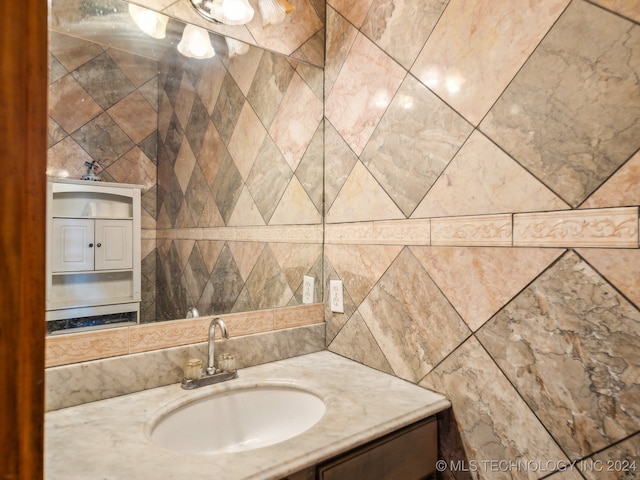 bathroom with vanity and tile walls