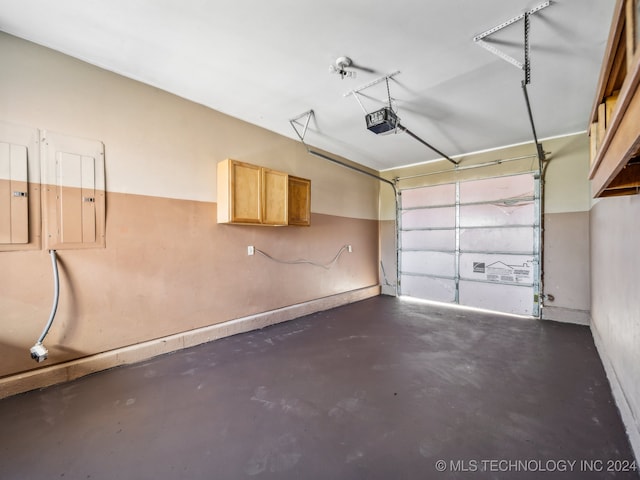 garage featuring electric panel and a garage door opener