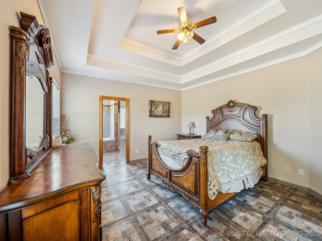 bedroom with ornamental molding, ceiling fan, connected bathroom, and a raised ceiling