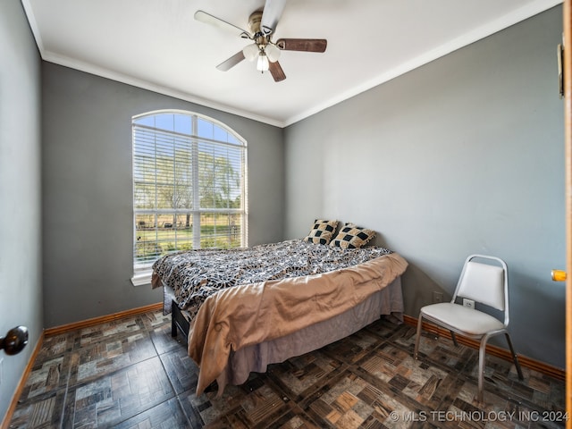 bedroom featuring ornamental molding and ceiling fan