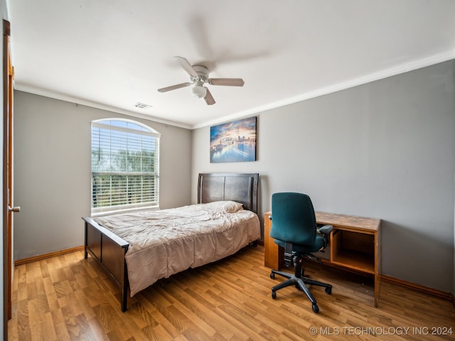 bedroom featuring crown molding, ceiling fan, and light hardwood / wood-style floors