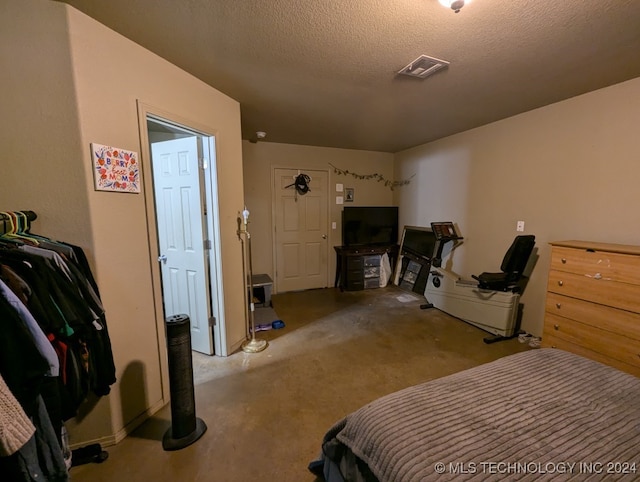 carpeted bedroom featuring a textured ceiling