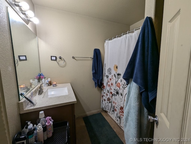 bathroom featuring vanity and curtained shower