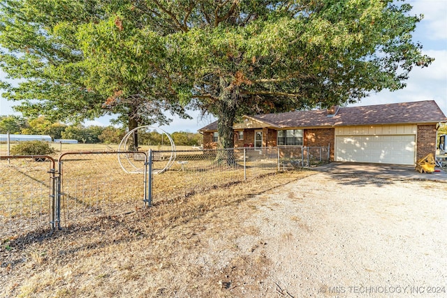 20515 S 4450, Vinita, OK 74301 - view of front facade with dirt driveway, fence, a garage, and brick siding