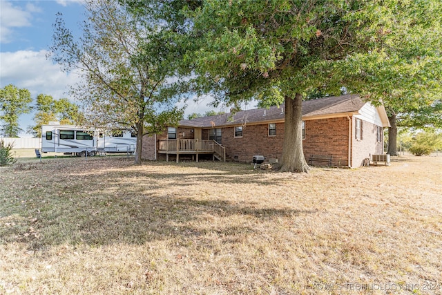 exterior space with a deck and a lawn