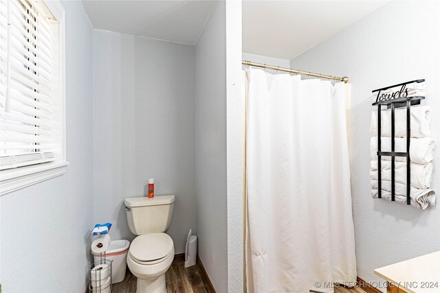 20515 S 4450, Vinita, OK 74301 - bathroom with wood finished floors, toilet, and a shower with shower curtain