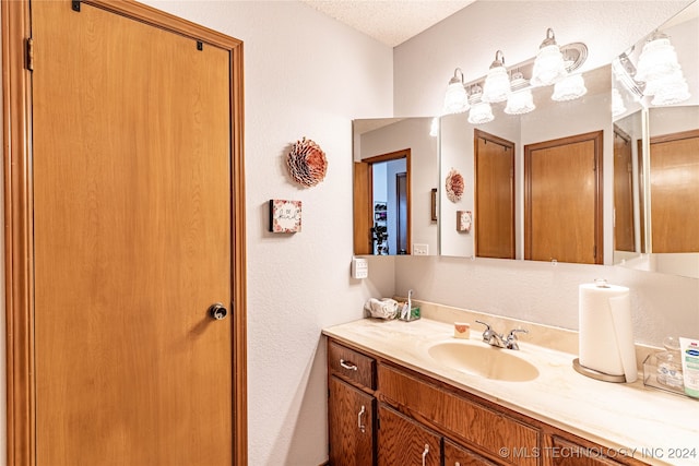 bathroom featuring vanity and a textured ceiling