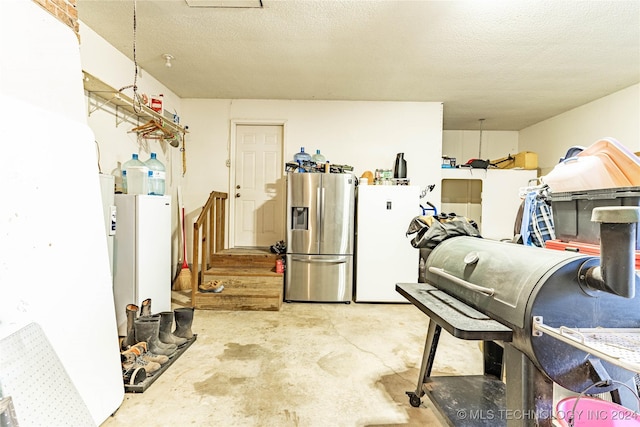 20515 S 4450, Vinita, OK 74301 - kitchen featuring stainless steel fridge, concrete flooring, freestanding refrigerator, and a textured ceiling