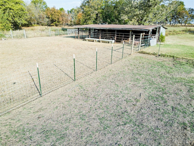 view of yard with a rural view and an outbuilding