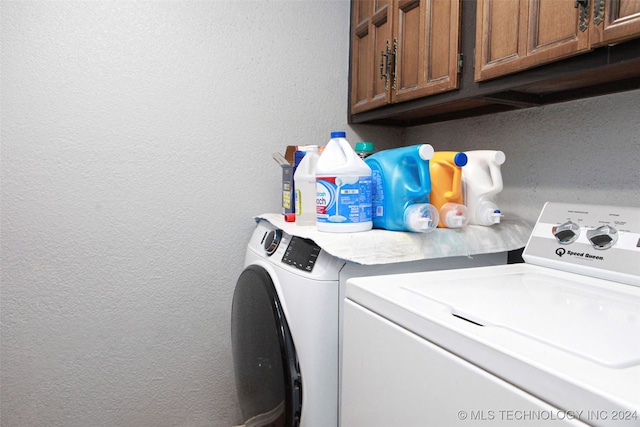 laundry area featuring cabinets and washing machine and dryer