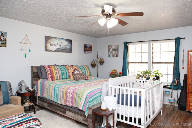 bedroom featuring a textured ceiling, dark hardwood / wood-style flooring, and ceiling fan