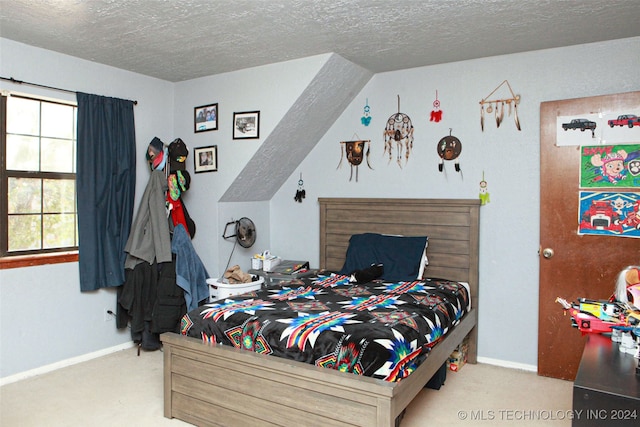 carpeted bedroom with a textured ceiling