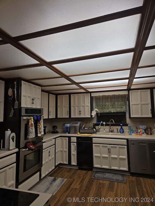 kitchen with white cabinets, dark hardwood / wood-style flooring, sink, and stainless steel appliances