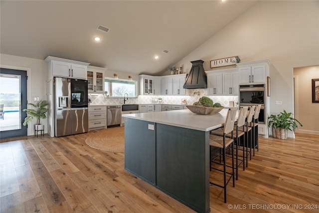 kitchen featuring white cabinetry, stainless steel appliances, and light hardwood / wood-style flooring