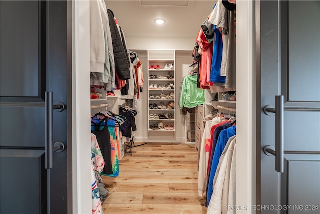 spacious closet featuring hardwood / wood-style flooring