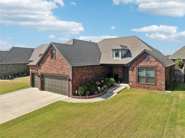 view of front of home featuring a garage and a front lawn