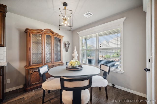 dining room featuring an inviting chandelier and dark hardwood / wood-style flooring