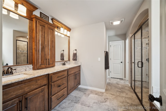 bathroom with an enclosed shower and vanity