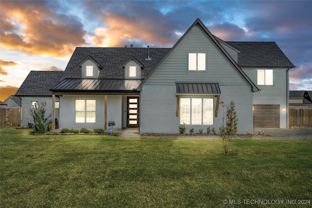 view of front of home with a lawn and a garage